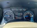 A 2014 Ford F-150 dashboard showing the speedometer, tachometer, and a digital display with trip information and fuel economy statistics
