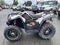 A 2017 Polaris Scrambler ATV with large tires and a rugged design, showcasing its drivetrain and seating area