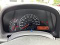 The dashboard of a 2020 Nissan NV200 displaying the speedometer odometer fuel gauge and warning lights