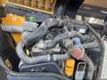 Close-up of the engine compartment of a 2013 JCB 510-56 Loadall showing various pipes filters and components