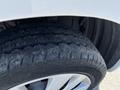 Close-up of a tire on a 2019 Nissan NV200 showcasing the tread pattern and alloy wheel design