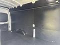 Interior of a 2021 Ford Transit van showing an empty cargo space with a flat floor and black walls