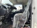 Interior of a 2018 Hino 338 truck featuring a steering wheel dashboard and seating covered in plastic wrapping