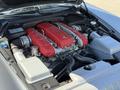 A 2005 Ferrari 612 Scaglietti engine featuring a V12 configuration with red valve covers and silver engine components