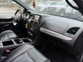 A 2020 Dodge Grand Caravan interior featuring a black leather dashboard and seating with a central control panel and touchscreen display