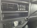 Interior view of a 2016 Chevrolet Express featuring dashboard vents a power outlet and a rotary knob for climate control
