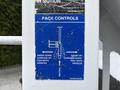 A blue control panel with instructions for operating pack controls on a 2014 Hino 195 featuring arrows indicating different handle movements and labeled positions