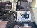 Interior view of a disassembled 2013 Ford Expedition showing the driver's side door frame and parts including wiring and a panel removed from the interior