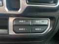 Four auxiliary buttons labeled AUX 1 AUX 2 AUX 3 AUX 4 on the dashboard of a 2020 Jeep Wrangler