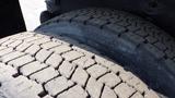 Close-up of the treaded tires of a 2003 International 5600i showing detailed grooves and texture