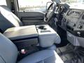Interior view of a 2013 Ford F-250 SD showing the front seats with a center console and dashboard details