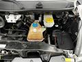 The engine compartment of a 2018 RAM Promaster showing various components including a coolant reservoir and hoses