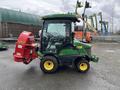 A 2014 John Deere 1585 Terrain Cut mower with a red attachment on the front viewed from the side