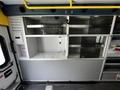 A 2013 Chevrolet Express with empty shelving and compartments visible inside the vehicle's interior