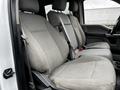 Interior view of a 2017 Ford F-550 featuring two front seats with gray fabric upholstery and a center console between them
