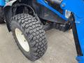 A close-up of a tire from a 2016 New Holland T475 tractor showcasing its textured tread and large size