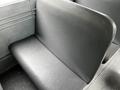 A black vinyl seat inside a 2015 Spartan School Bus with a smooth surface and simple design