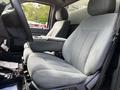 Front seats of a 2016 Ford F-550 featuring plush gray fabric upholstery and a spacious design with a center armrest