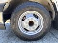 A close-up view of a silver alloy wheel with a black tire of a 2020 Chevrolet Express