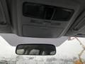 Interior view of a 2016 Subaru Forester showing the ceiling console and rearview mirror with rain droplets on the windshield