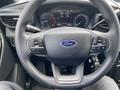 Steering wheel of a 2021 Ford Explorer with various control buttons and a Ford logo in the center