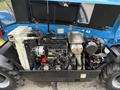 A 2020 Genie GTH-5519 with its engine compartment open revealing the engine components and machinery inside