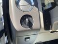 Close-up of the headlight control knob in a 2013 Ford Expedition showing various light settings and a textured surface