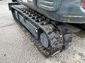 A close-up view of the tracked undercarriage of a 2022 Hyundai R55-9A excavator showing the rubber track and wheel components