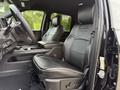 Interior of a 2024 RAM 2500 showing black leather seats and a steering wheel with controls