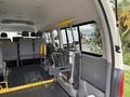 Interior of a 2009 Toyota Hiace showing foldable seats and a wheelchair lift mechanism installed on the side