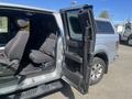 A 2014 Ford F-150 truck with an open door revealing the interior seating and console area