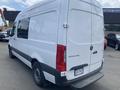 A 2022 Mercedes-Benz Sprinter van in white with a high roof and cargo area visible on the rear doors