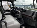 Interior of a 2006 Freightliner M2 112 showing a driver's seat dashboard and controls