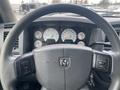 Close-up view of the steering wheel and dashboard of a 2008 Dodge Ram 5500 featuring gauges and control buttons