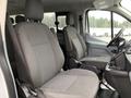 Interior view of a 2017 Ford Transit showing two gray fabric seats with a central console between them