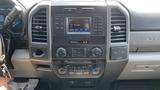 Dashboard of a 2019 Ford F-550 featuring a central display screen for audio and climate controls with various buttons and knobs