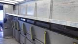 2011 Ford Econoline cargo van interior with metal shelves and yellow supports for cargo storage