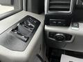 The interior panel of a 2016 Ford F-150 featuring control buttons for windows mirror adjustments and light settings