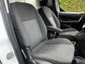 Two gray cloth front seats of a 2014 Ford Transit Connect with a simple design and armrests