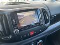 A dashboard display screen showing a rearview camera view in a 2015 Fiat 500L with colored guide lines indicating parking space directions