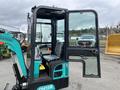 A 2024 AGT Industrial Green QH13R Mini Excavator with an open door revealing the operator's seat and controls inside