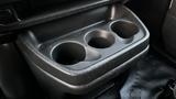 A black plastic cup holder with three circular compartments designed for holding beverages in a 2005 Chevrolet Express