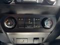 Close-up of the climate control panel in a 2016 Ford F-150 featuring knobs for temperature and air flow settings along with an A/C button
