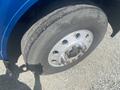 A close-up of a wheel from a 2008 Peterbilt 340 showcasing the tire tread and metal rim with visible lug nuts and brand markings