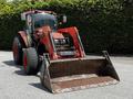 A 2011 Kubota M8540D tractor with a front loader attachment featuring large tires and a prominent metal bucket at the front