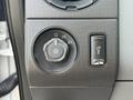 A control panel featuring a dial for headlights and parking lights with a small switch for additional features on a 2011 Ford F-350 SD