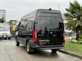 A black 2022 Mercedes-Benz Sprinter van viewed from the rear with a high roof and large windows