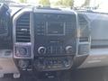 Interior dashboard of a 2017 Ford F-150 featuring a display screen and various control knobs for climate and audio settings