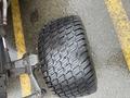 A close-up view of a rubber tire from a 2010 Kubota F3680 featuring a deep tread pattern designed for traction on various surfaces