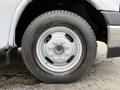 A close-up of a white wheel from a 2020 Chevrolet Express featuring a steel rim and a black tire with visible tread patterns